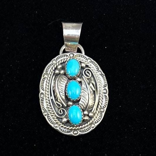 Sleeping Beauty turquoise oval sterling silver leaf work pendant